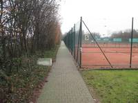 Befestigter Weg führt rechts an den Tennisplätzen vorbei