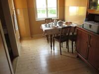 Ein Raum mit einem Küchenbuffet und einem Esstisch mit 4 schlichten Holzstühlen